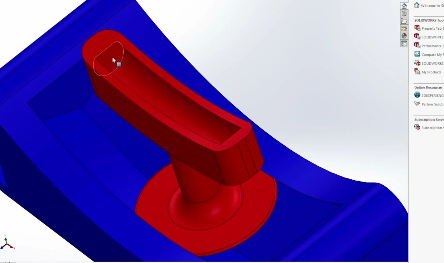 The same part in SolidWorks: a blue curved base with a red T-shaped handle standing in its groove.
